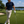 Golfer on a golf course holding a club with a scenic background