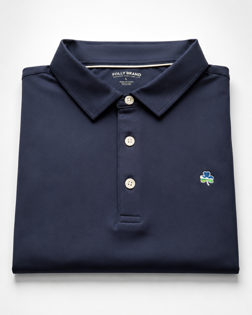 Folded navy polo shirt with a brand logo on a white background. Perfect for Father’s Day. 
